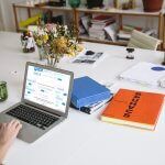 a group of people sitting at a table with a laptop