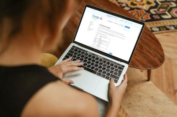 Over-the-shoulder view of a person using the Froala editor on a laptop.
